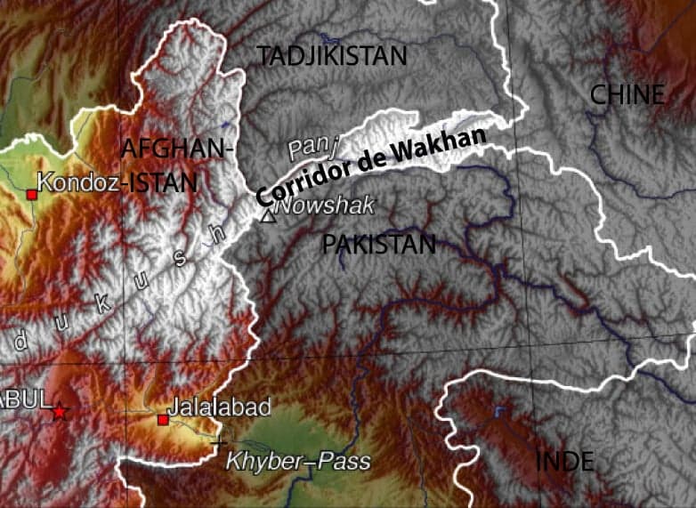 The wide Wakhan valley with a river glittering between grassy banks and snowy peaks
