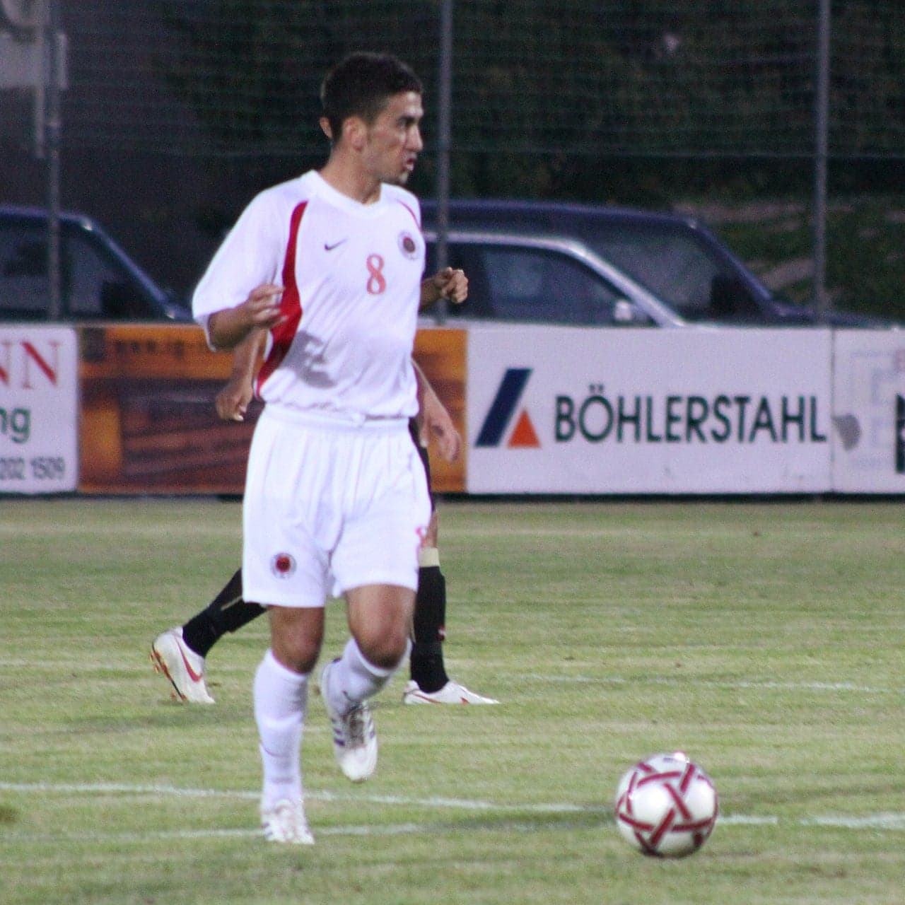 Albanian national football team players in red shirts on a pitch