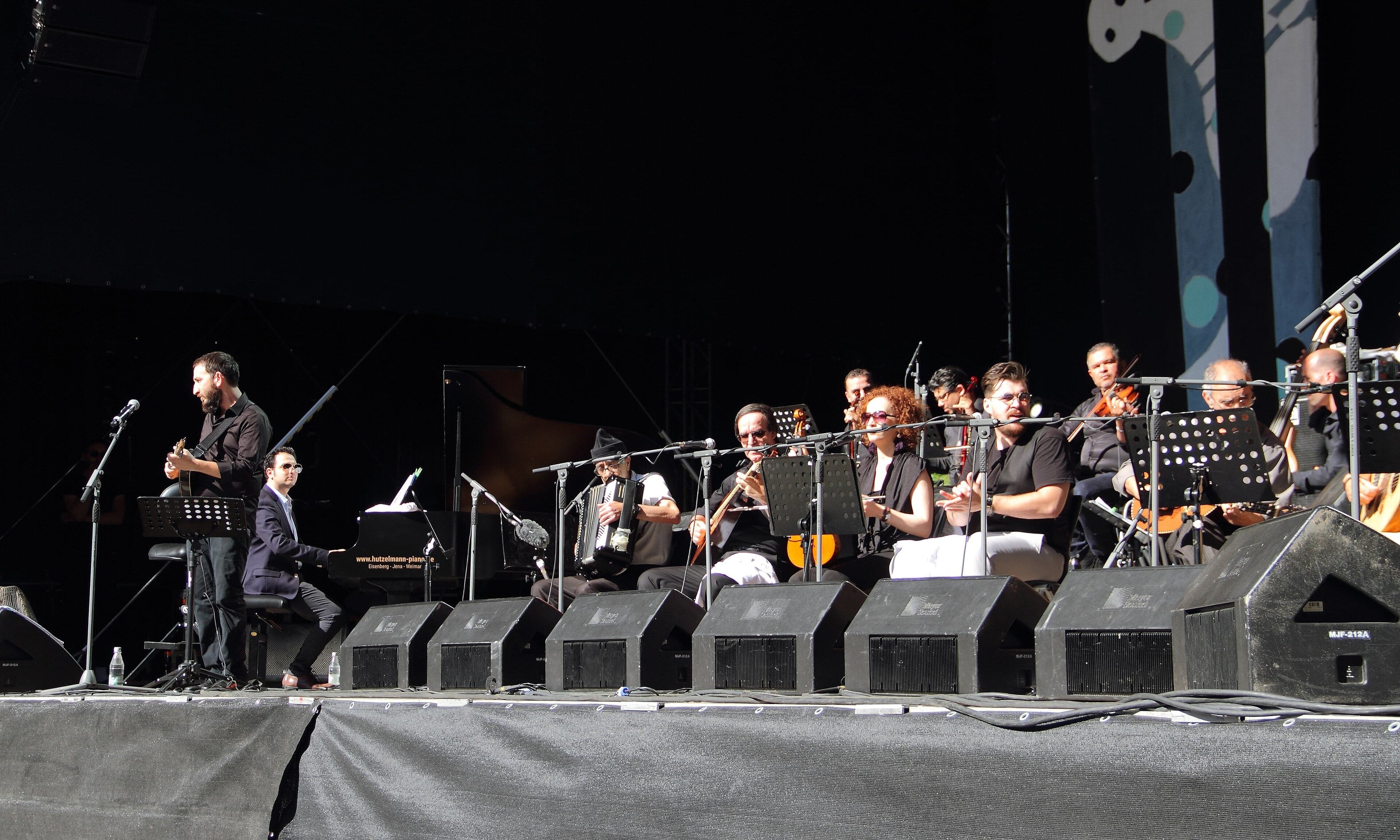 Chaabi musicians playing mandole, lute and small drums together in a café performance