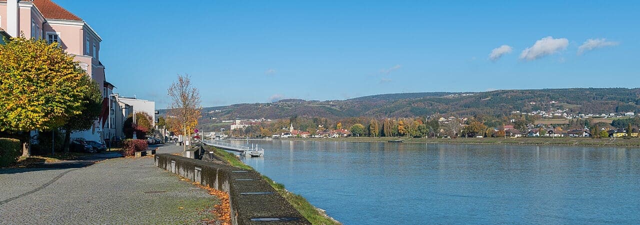 The Danube River flowing past Vienna with the city skyline in the background