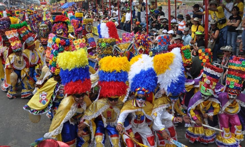 Colourful costumed dancers and musicians parading through the streets of Barranquilla