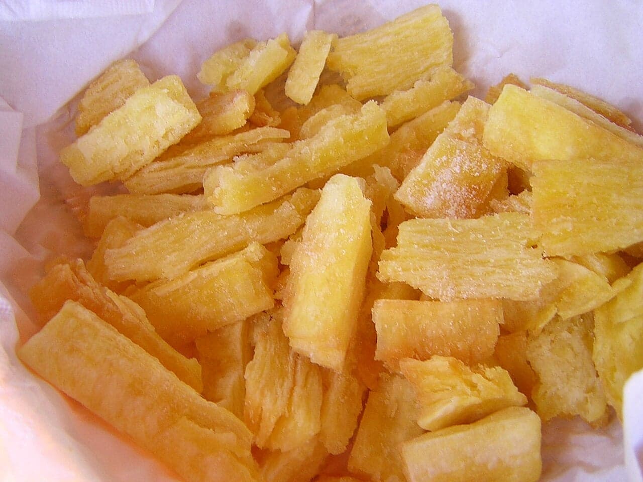 Golden crispy yuca frita served with curtido and chicharrón