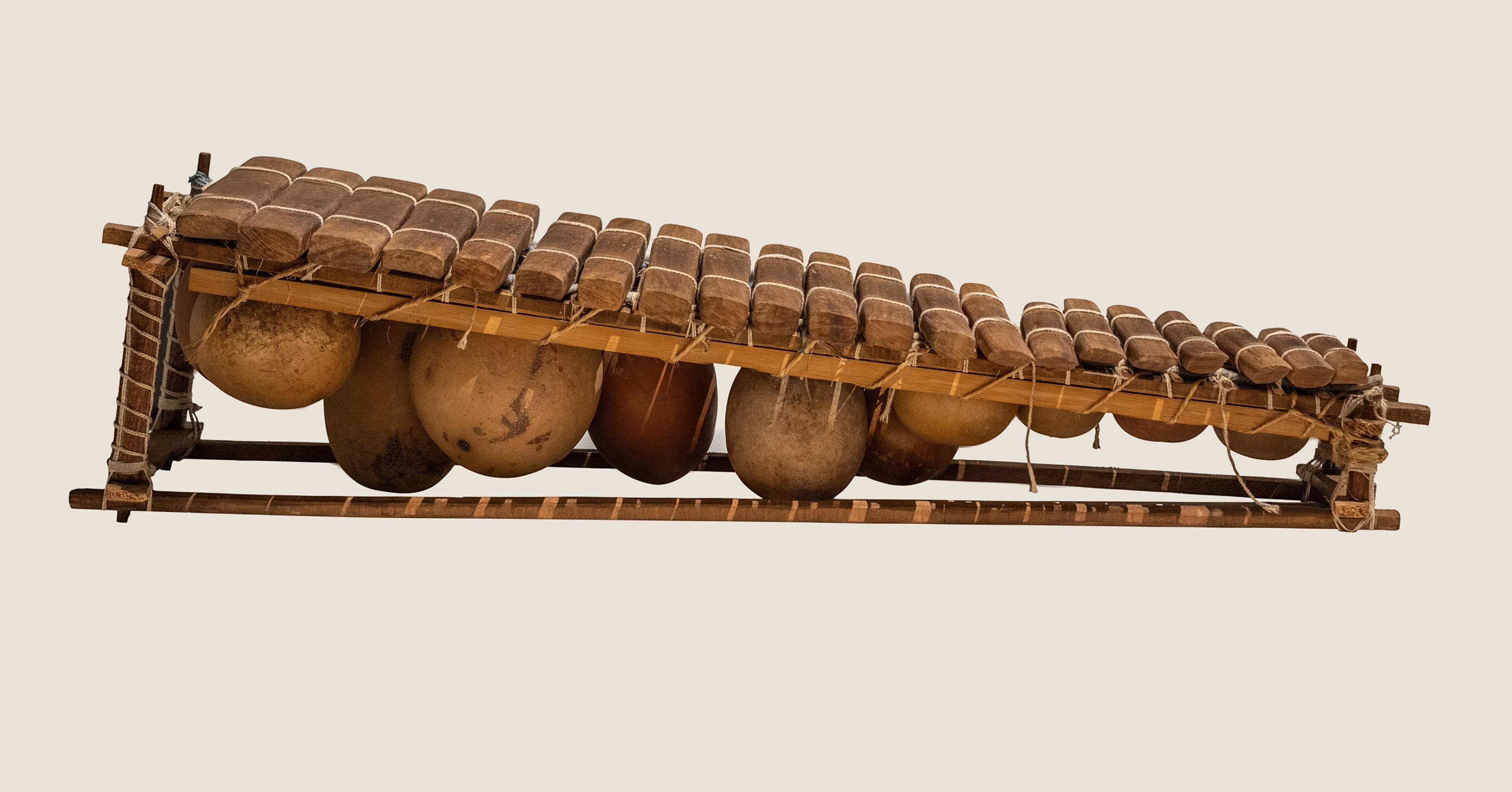 A balafon instrument with wooden keys and gourd resonators underneath