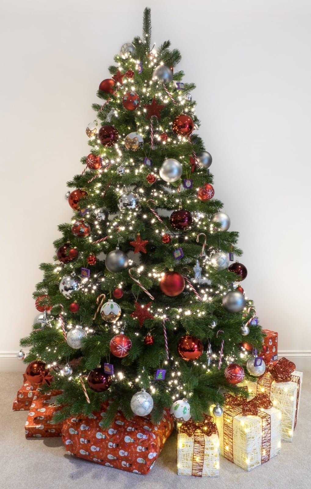 A decorated indoor Christmas tree with lights and ornaments