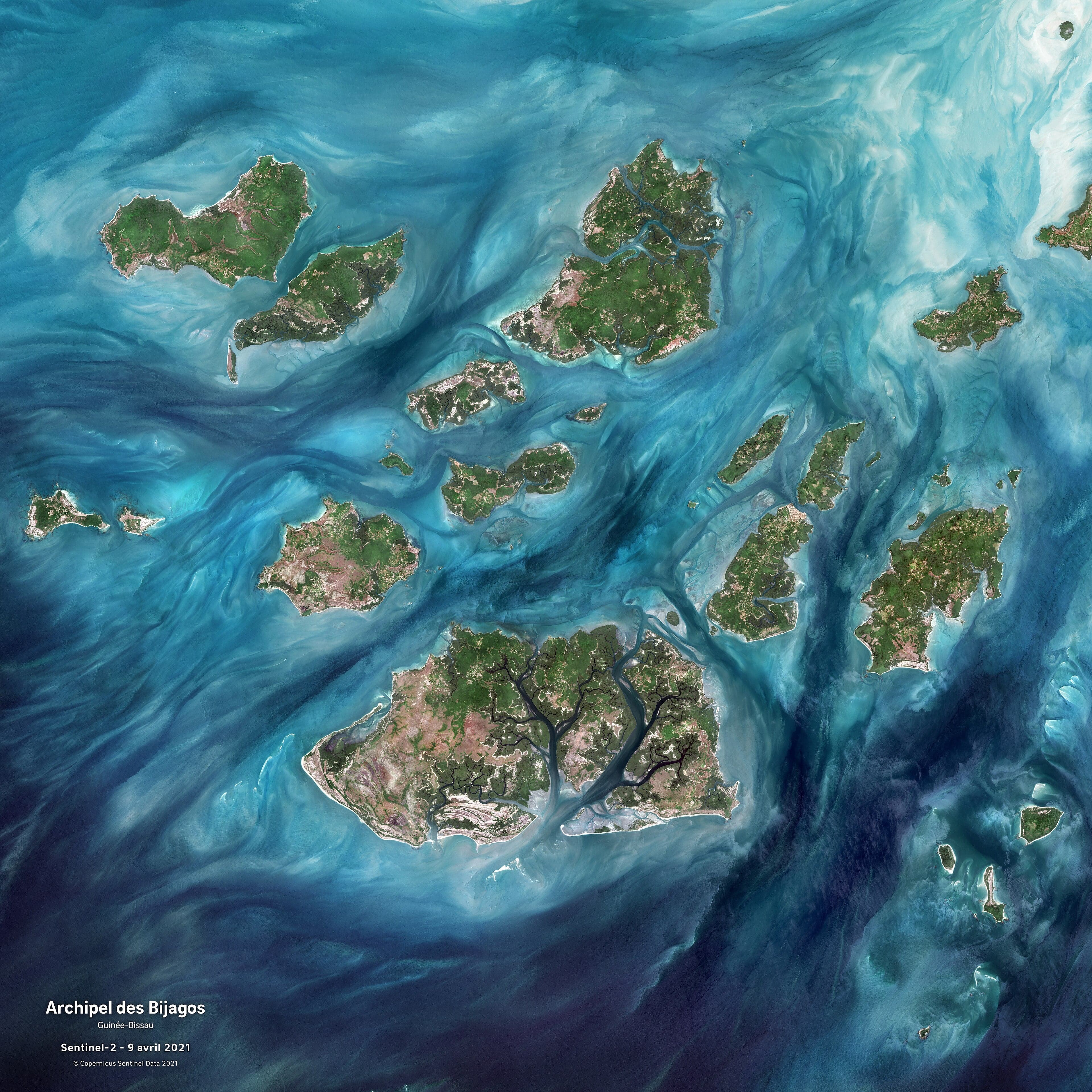 A view across the calm waters of the Bijagós islands with mangrove trees lining the shore