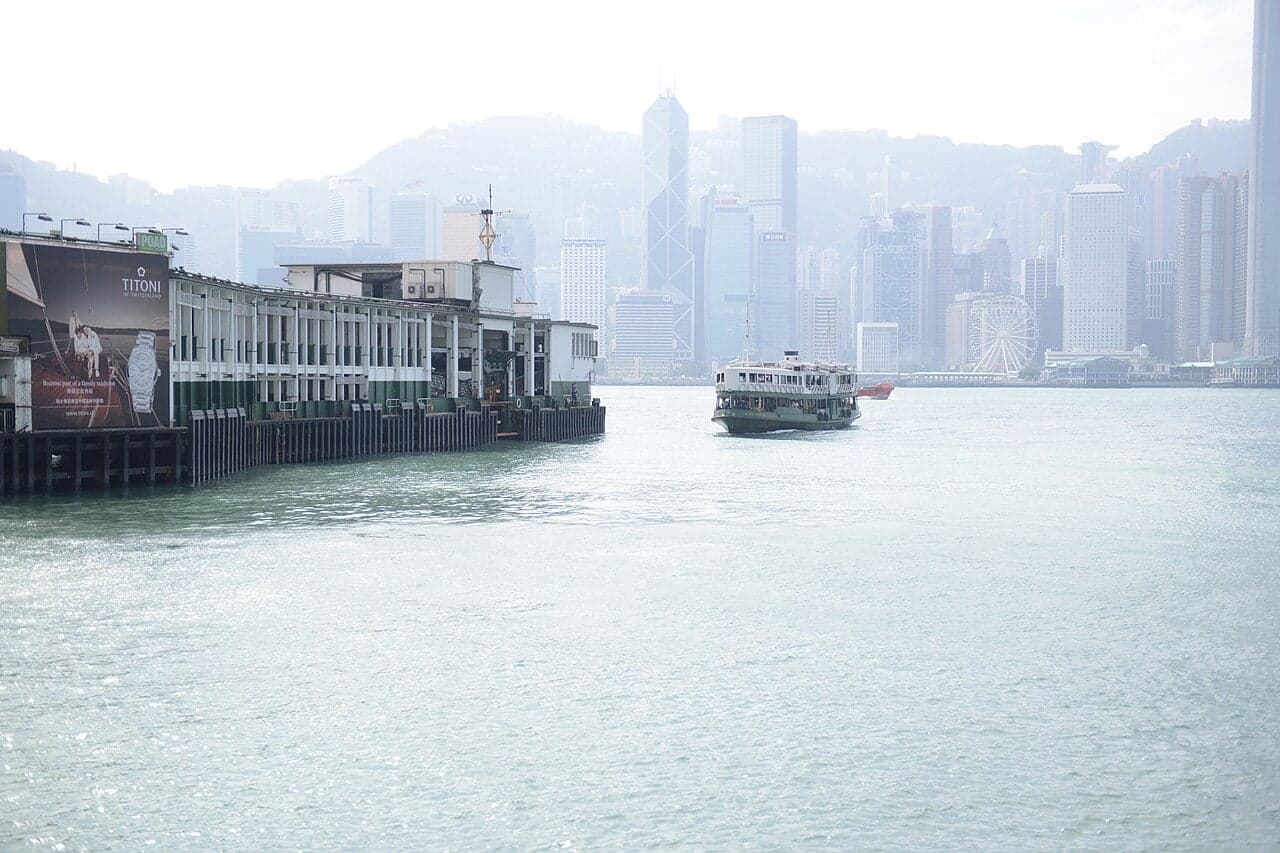 A green-and-white Star Ferry boat crossing Victoria Harbour