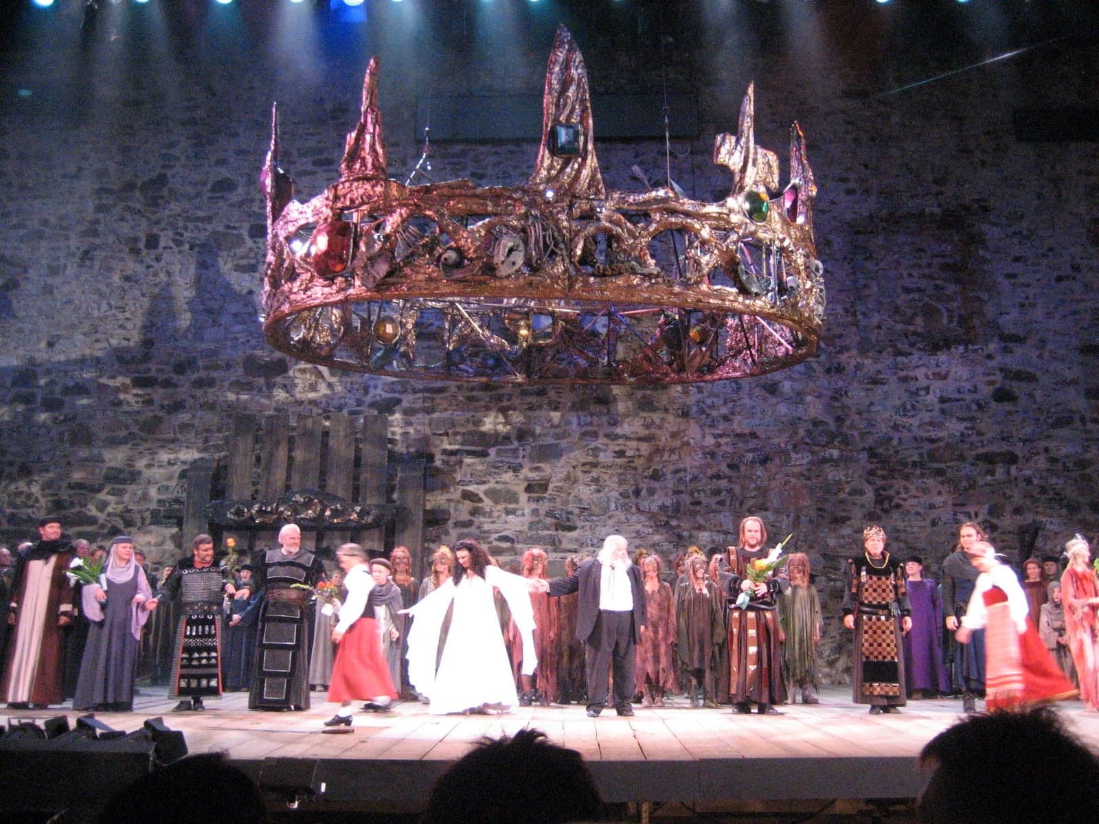 Opera performers in costume taking a bow on stage