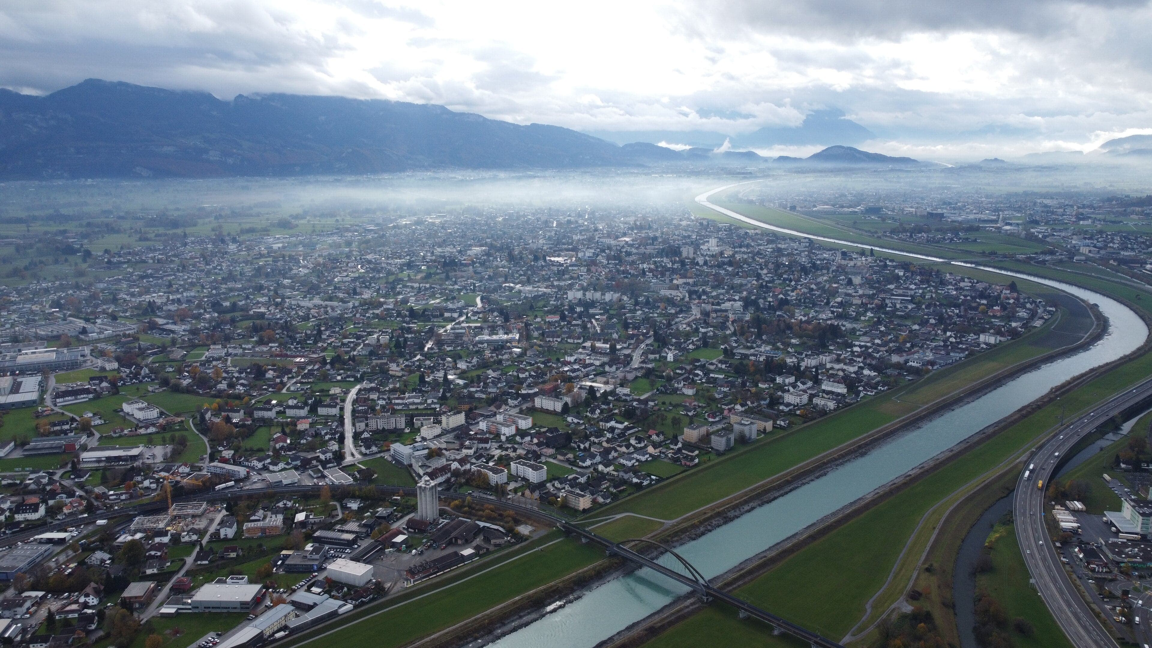 The flat green Rhine valley with mountains rising steeply on either side