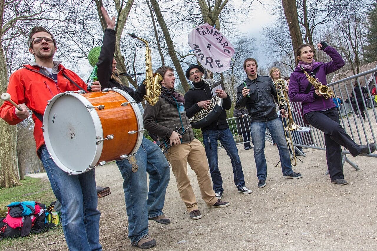 A Luxembourg fanfare brass band in uniform playing at an outdoor festival
