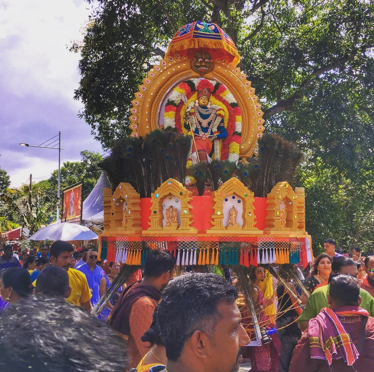 Colourful flower-decorated cavadee arches carried by devotees during Cavadee in Mauritius