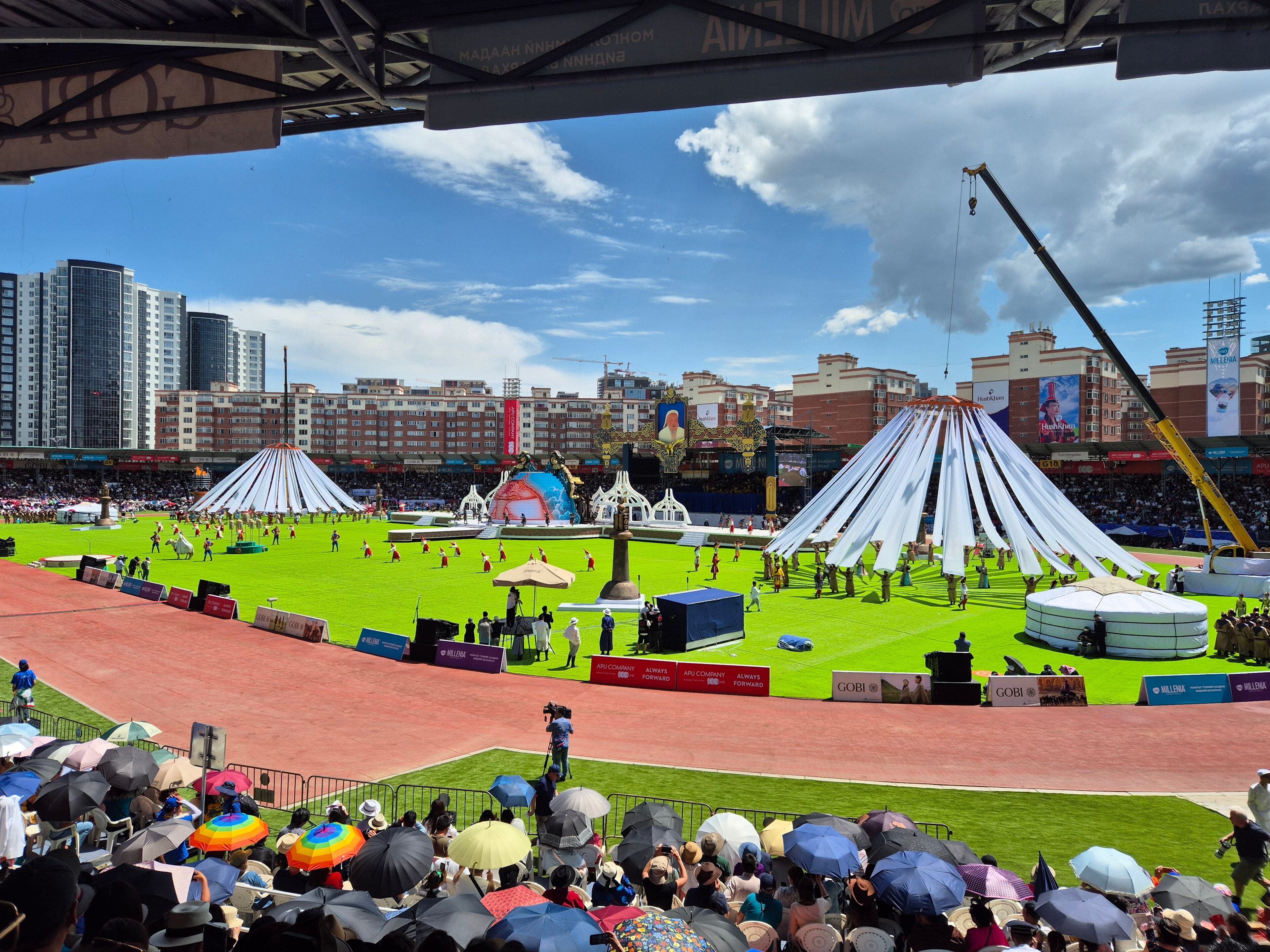 Mongolian wrestlers in traditional costume competing at the Naadam Festival