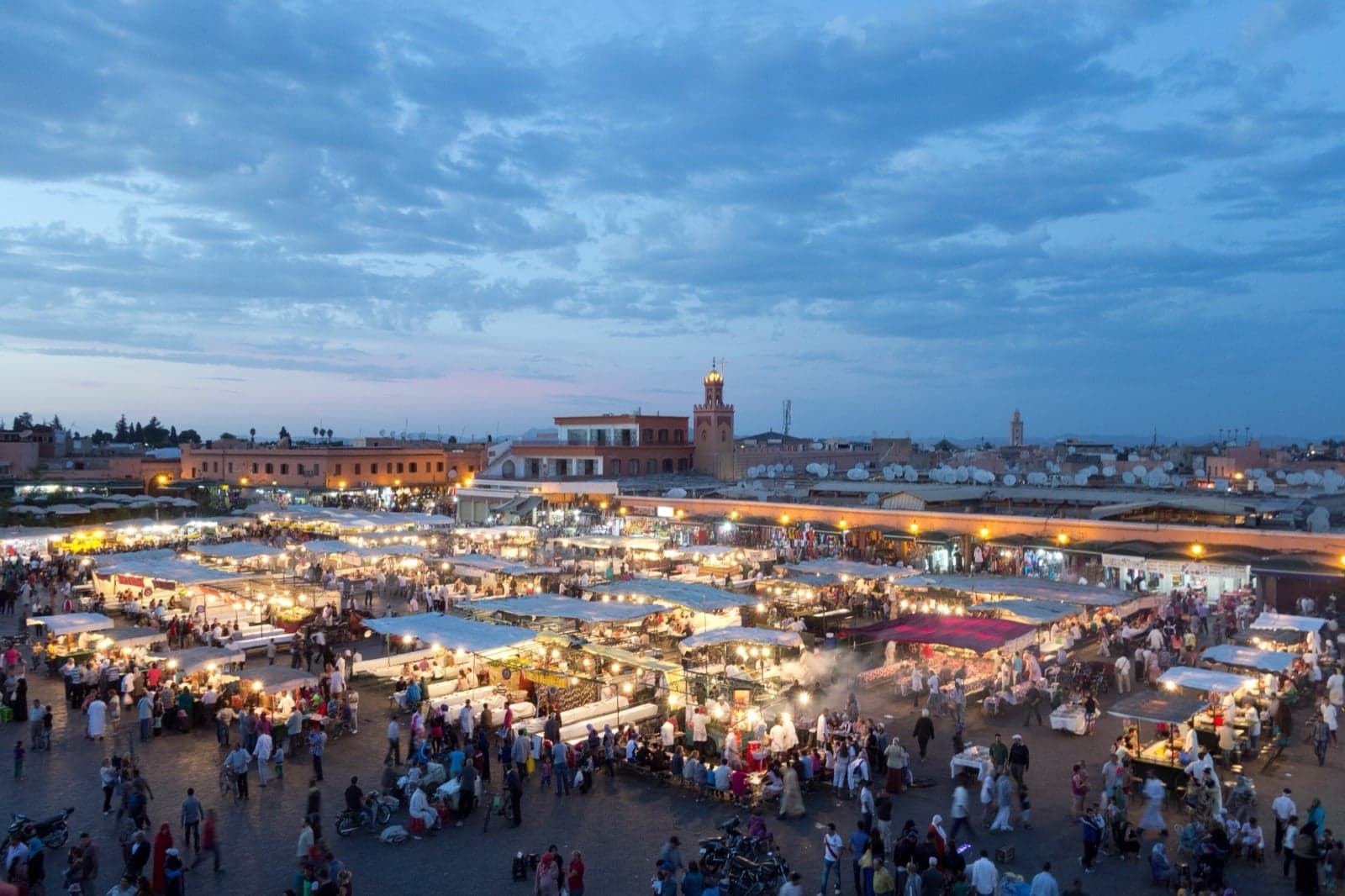 The busy main square of Marrakech with food stalls and drummers at dusk