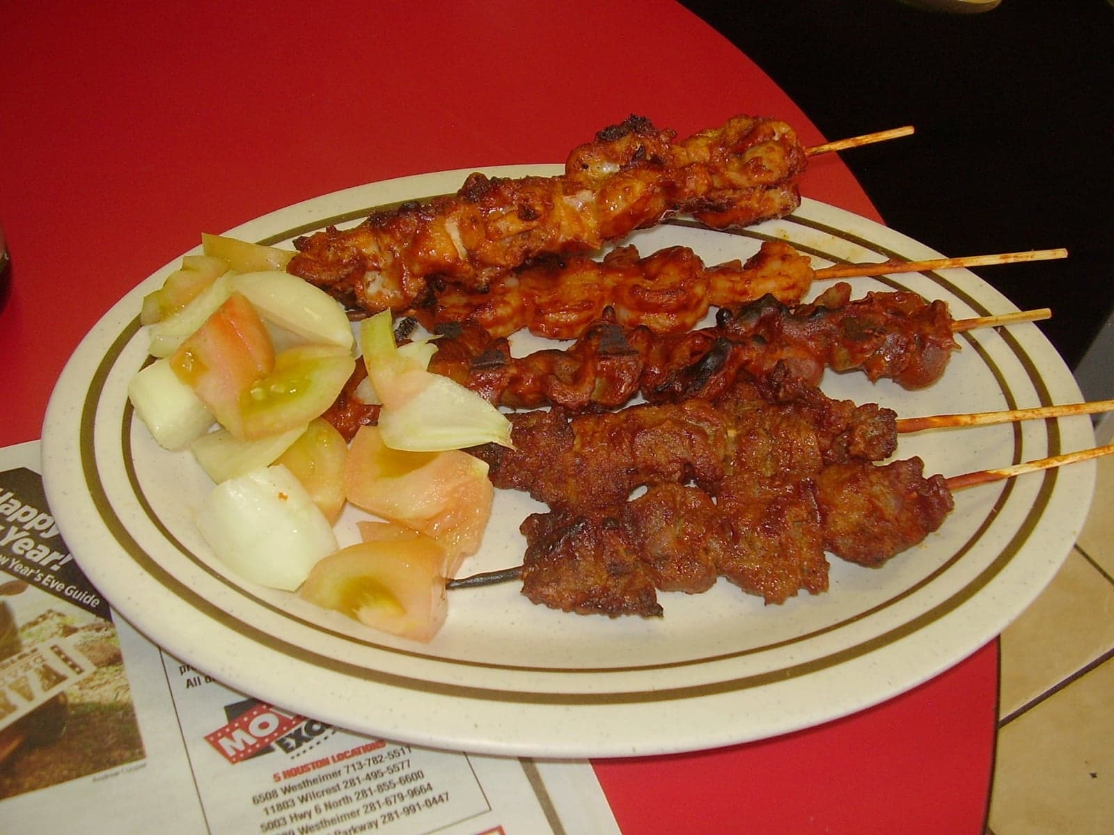 Suya - skewers of grilled spiced meat on a plate