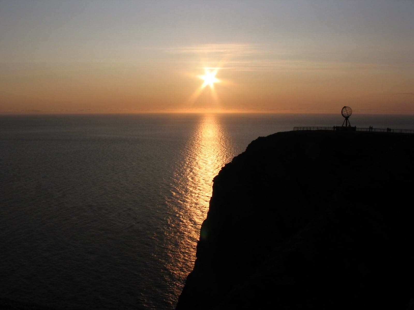 The sun glowing low over the sea at midnight in northern Norway