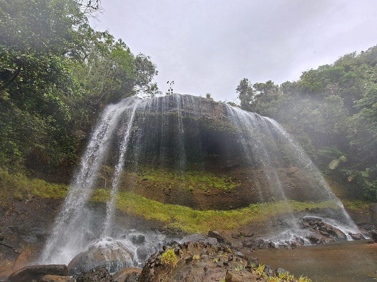 Ngardmau Waterfall cascading through lush green jungle in Palau
