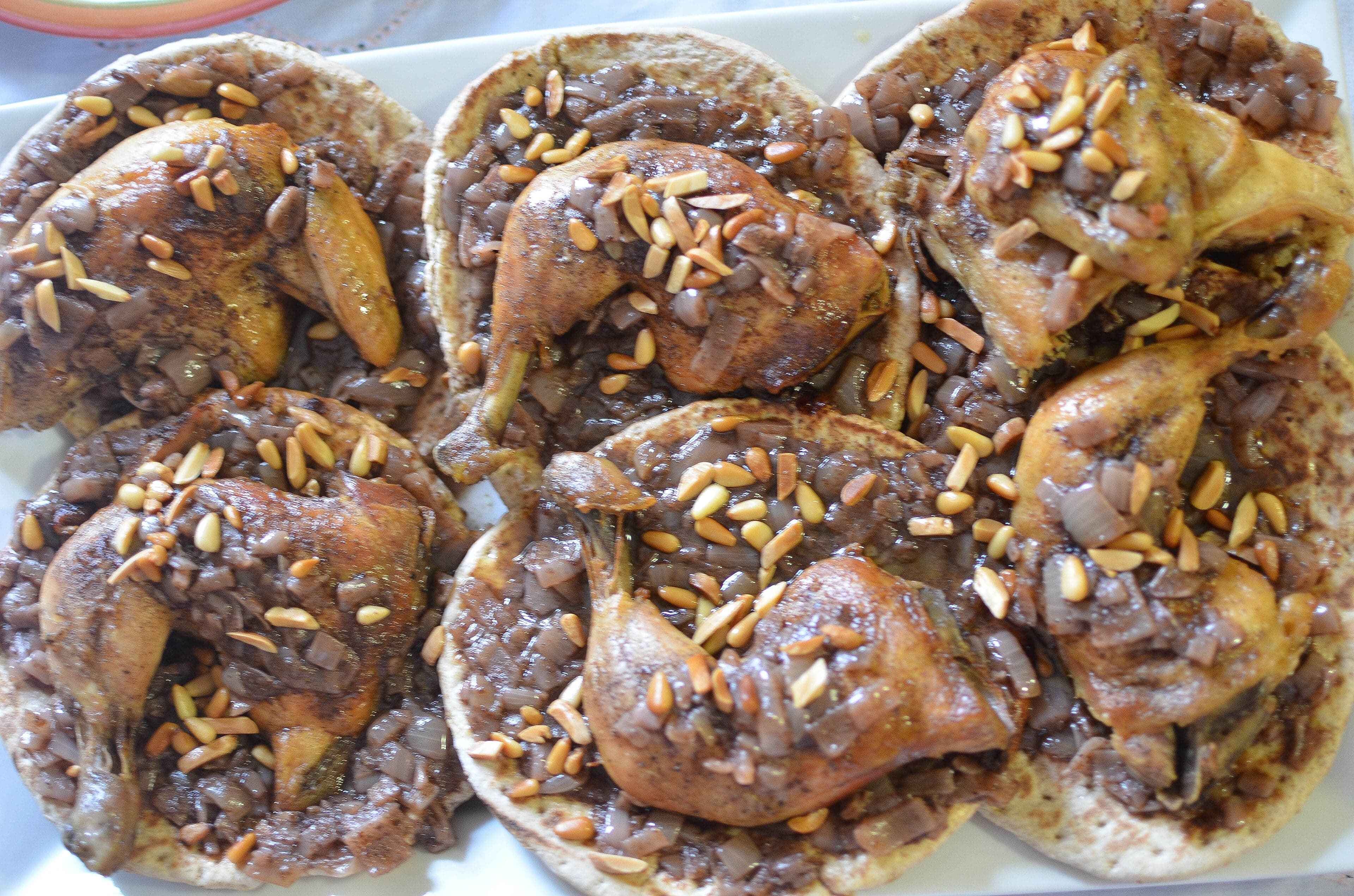 Musakhan - golden roast chicken pieces on flatbread with caramelised onion and sumac