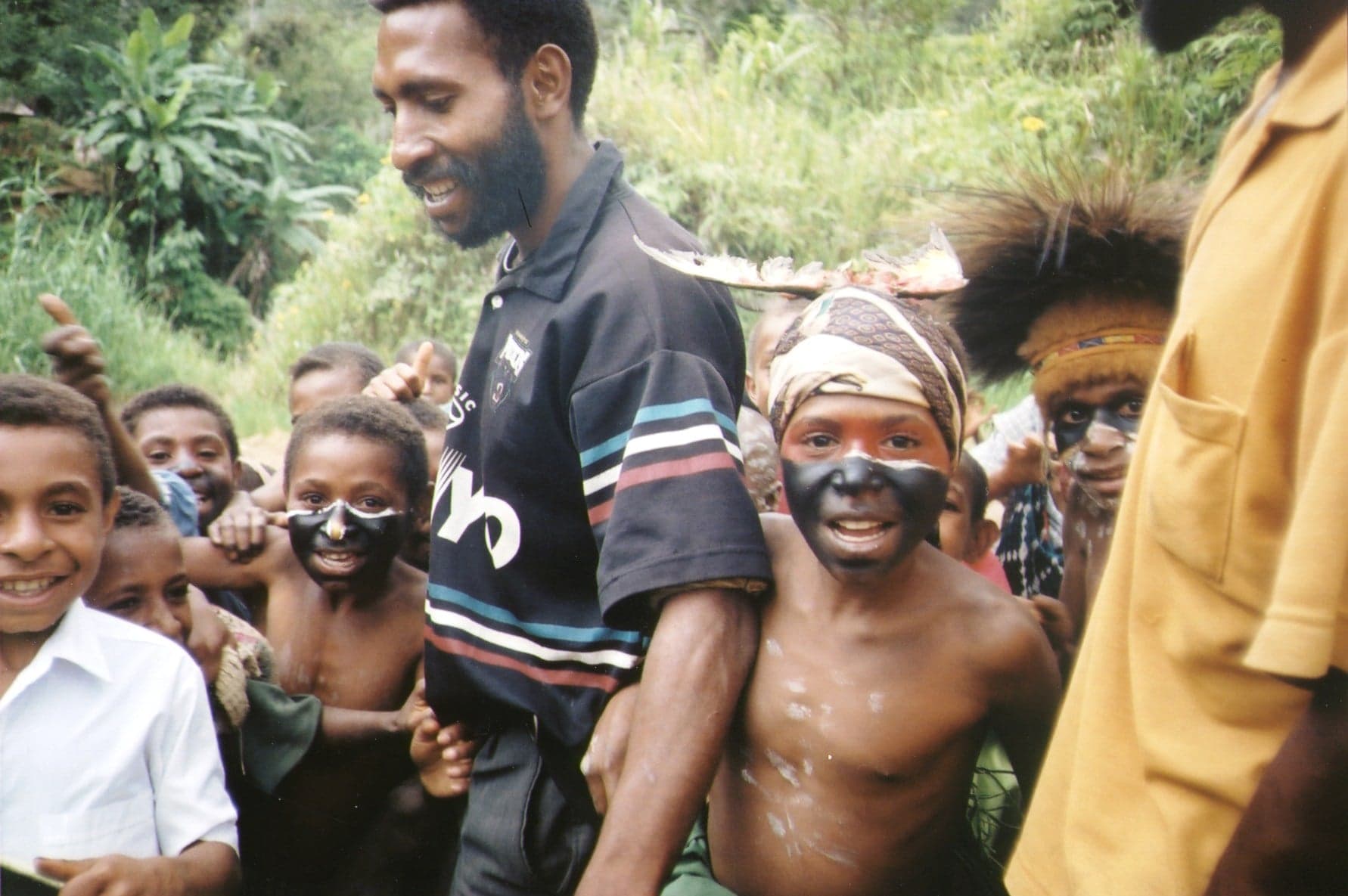 Dancers in elaborate feathered headdresses and painted faces at a PNG sing-sing