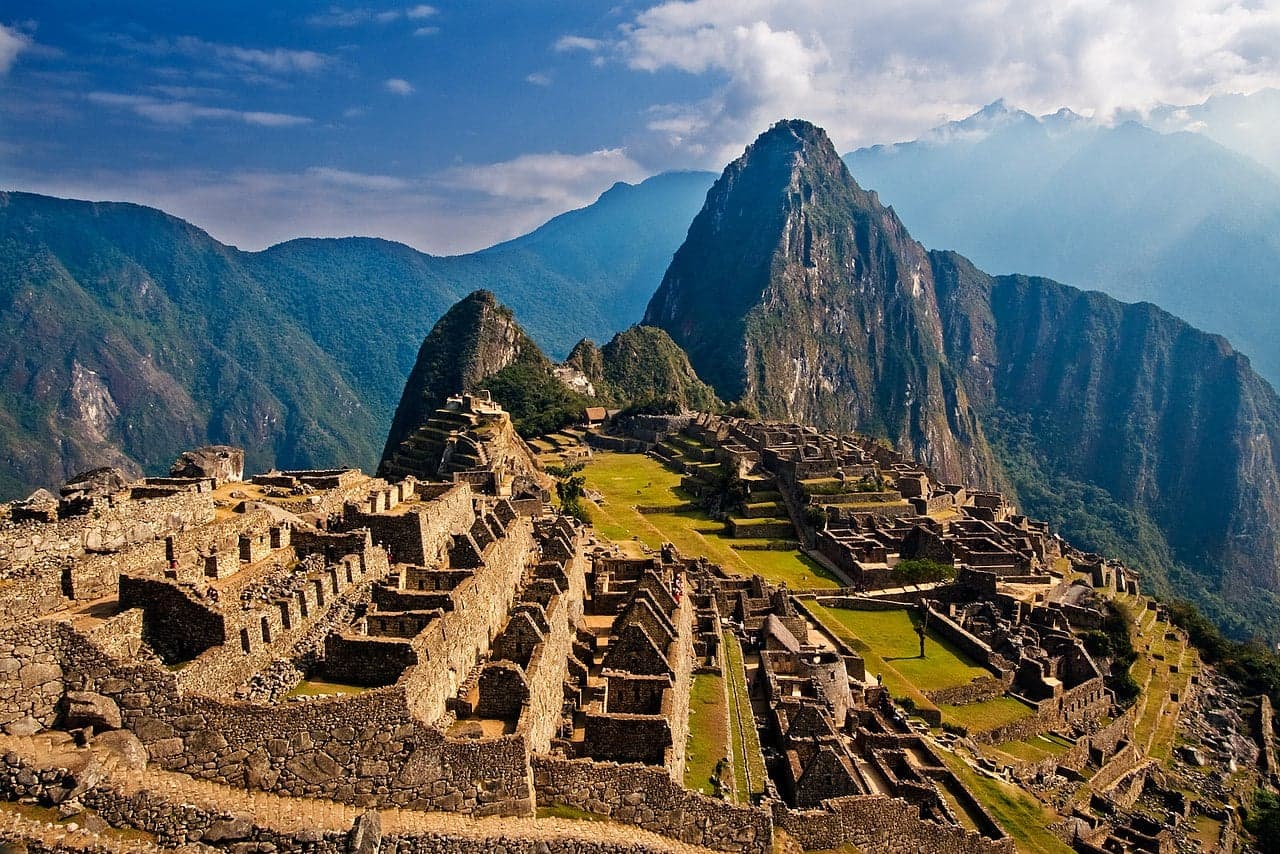 Stone terraces and houses of Machu Picchu with mountains behind