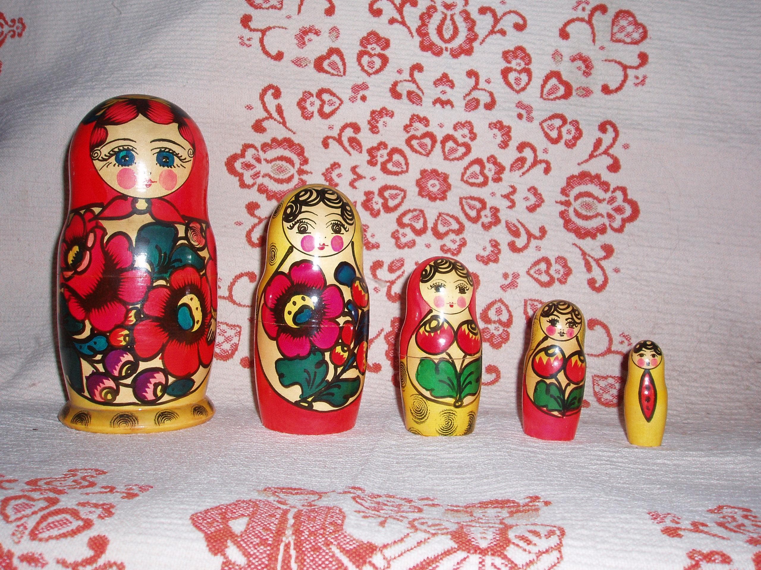 A set of brightly painted matryoshka nesting dolls arranged from largest to smallest
