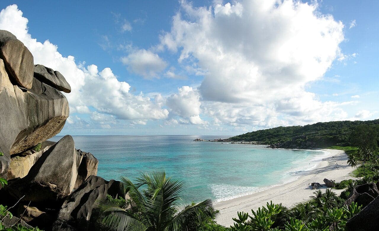 Aerial view of a green Seychelles island ringed by turquoise sea