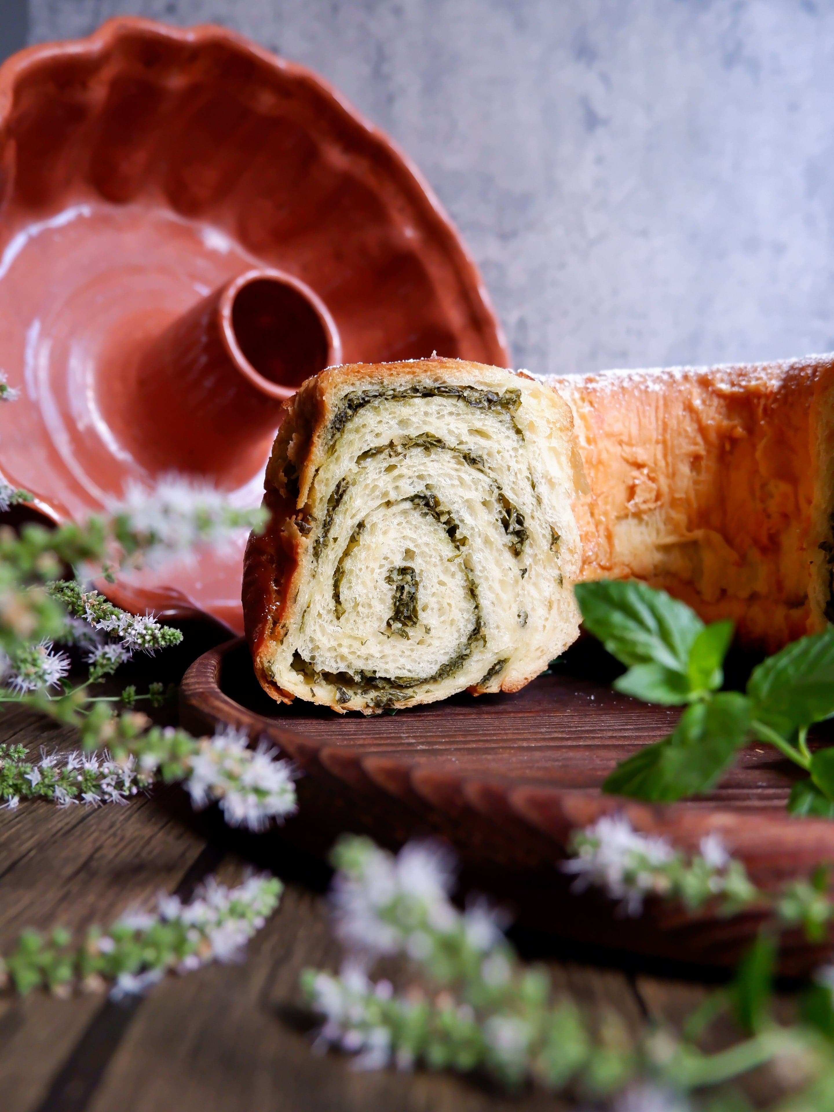 A round potica nut cake sliced to show the swirled walnut filling