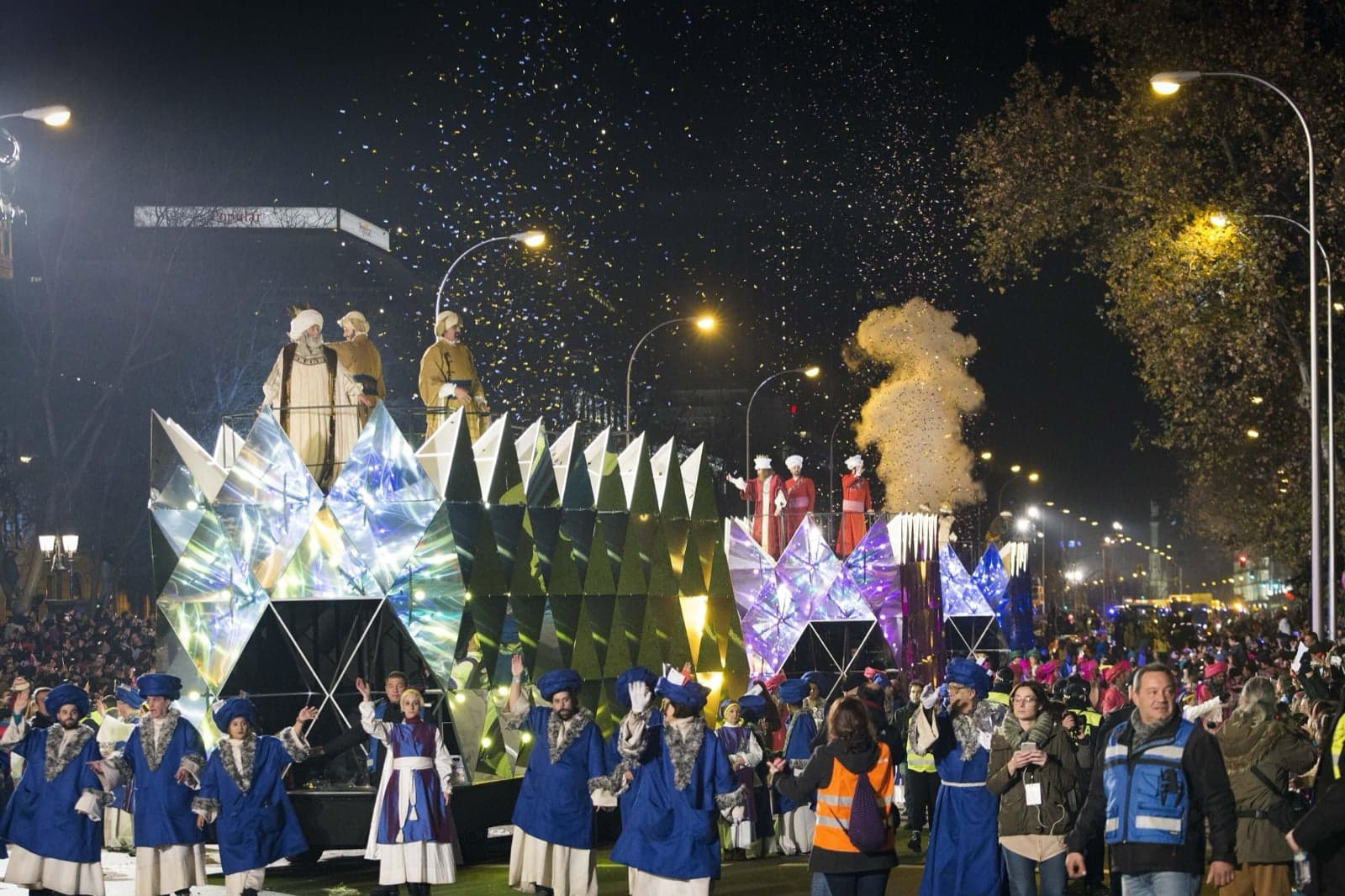 A bright parade float with colourful crystals and costumed performers at a Three Kings parade in Madrid