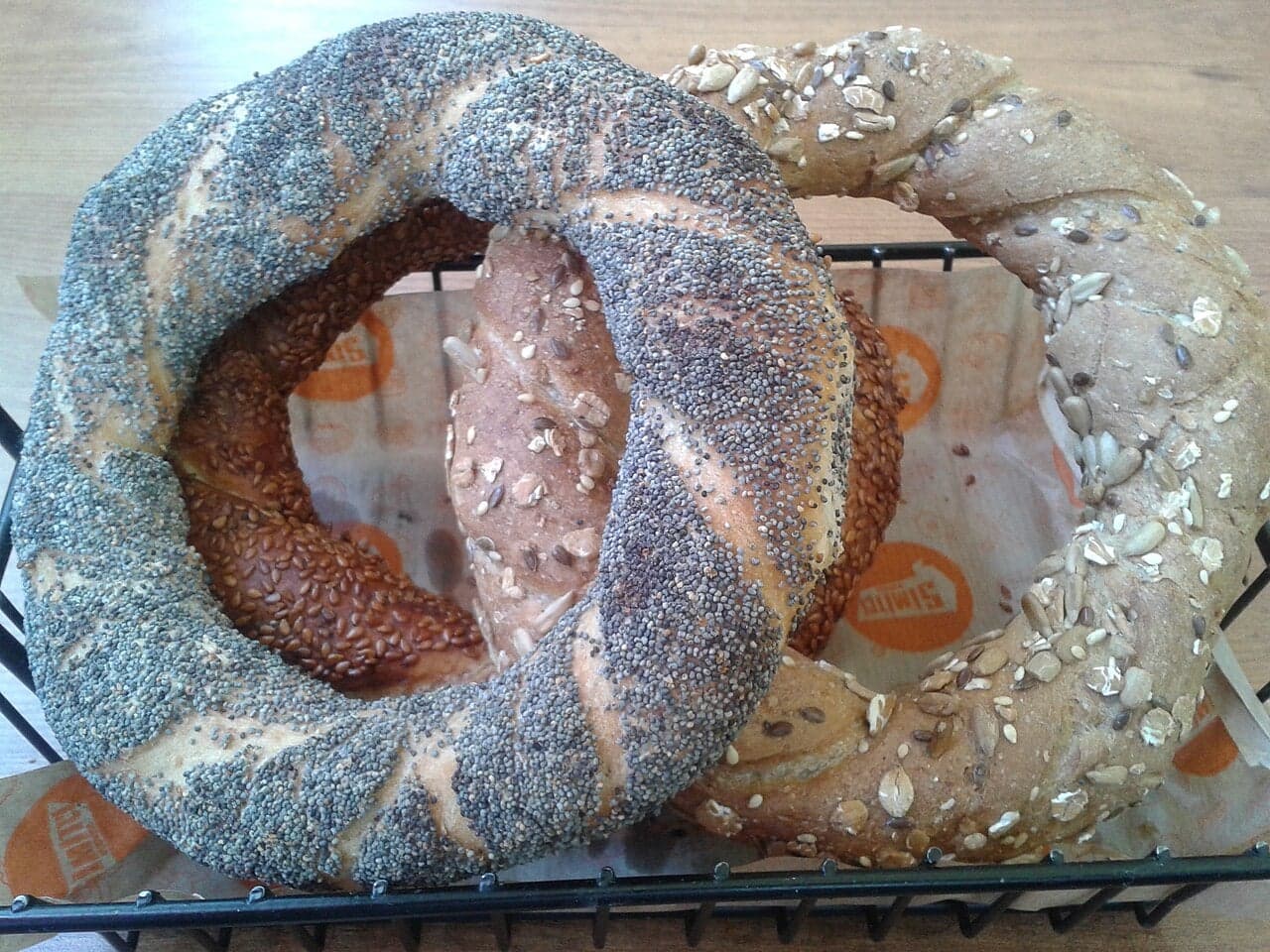 A pile of sesame-coated simit bread rings on a red Turkish street cart