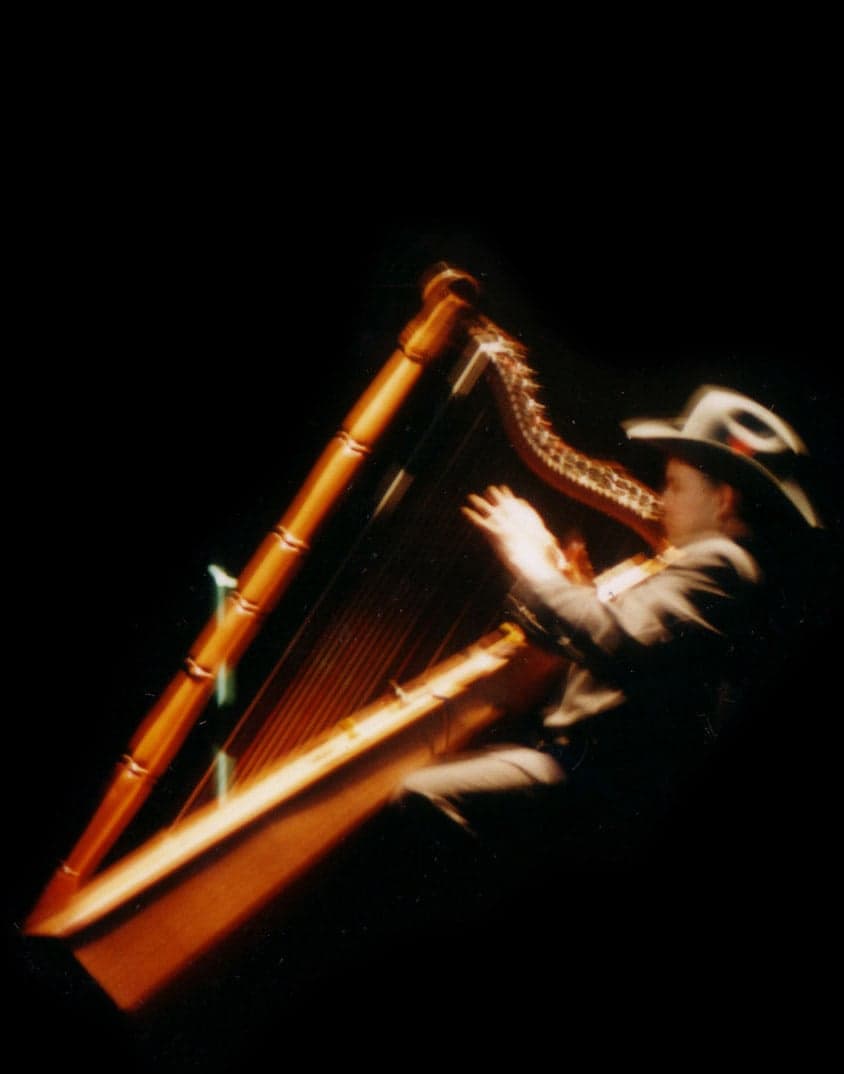 A llanero musician playing a Venezuelan harp