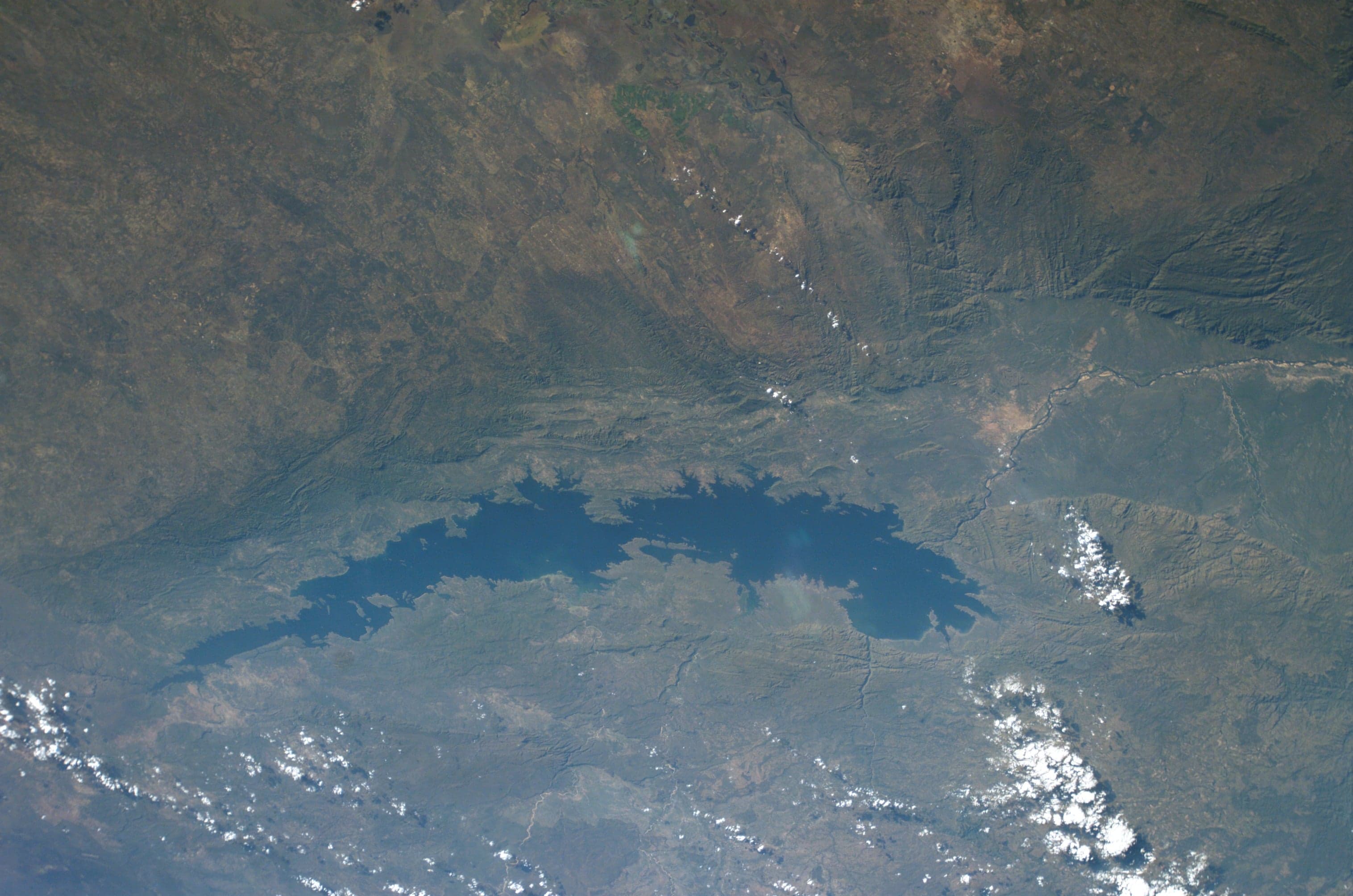 The wide blue surface of Lake Kariba with dead-wood trees standing in the water