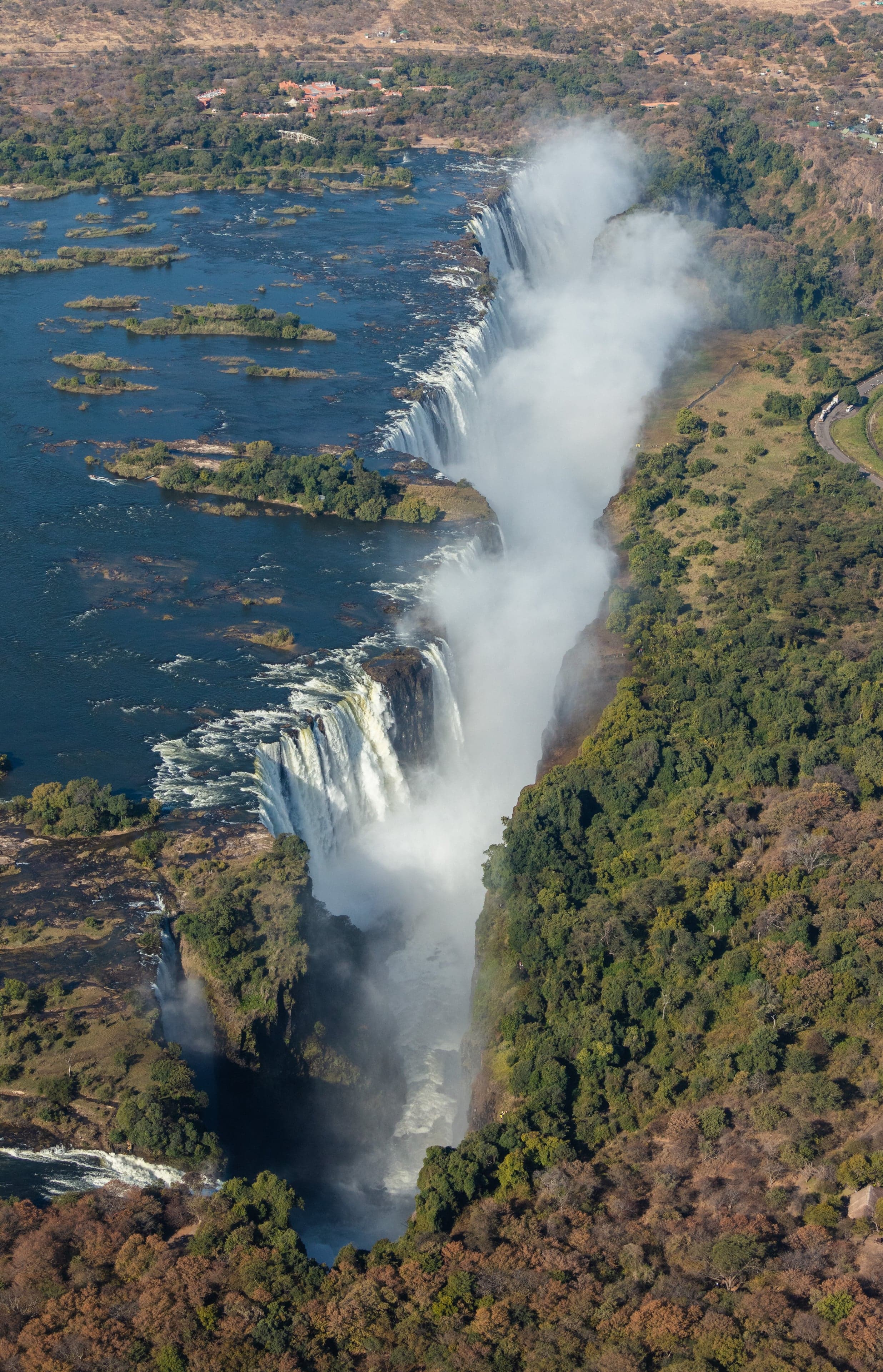 An aerial view of Victoria Falls with spray rising high into the air