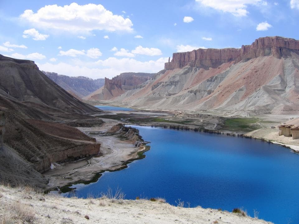 Deep turquoise Band-e-Amir lakes ringed by pale cliff walls under a bright sky