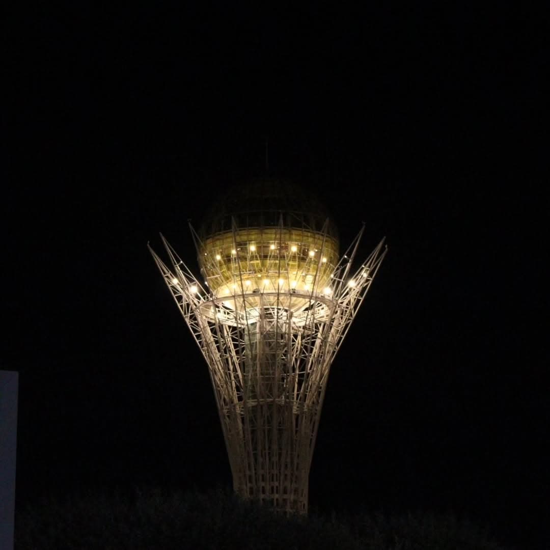 The Baiterek Tower and gleaming skyline of Astana under a bright blue sky