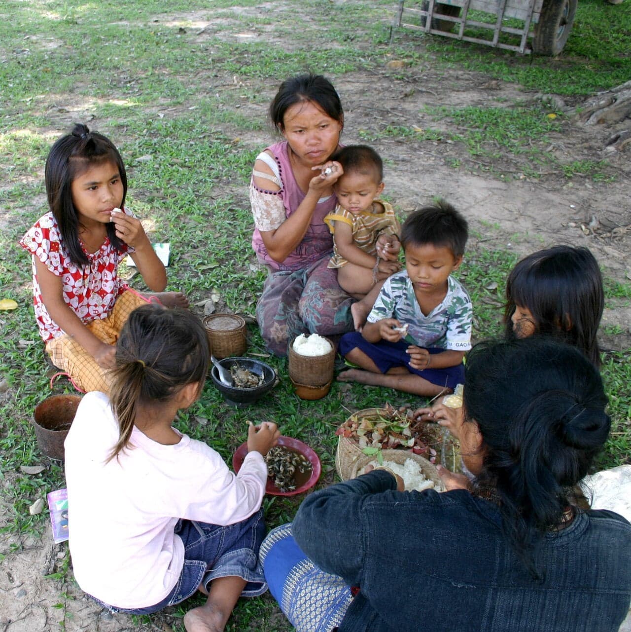Sticky rice in a traditional woven bamboo basket with a lid, served at a Lao meal