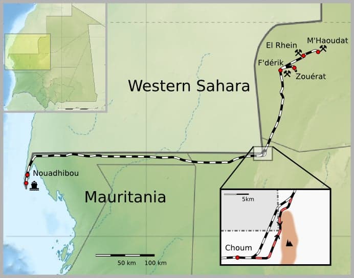 The Mauritanian iron-ore train stretching across the desert with wagons full of dark ore