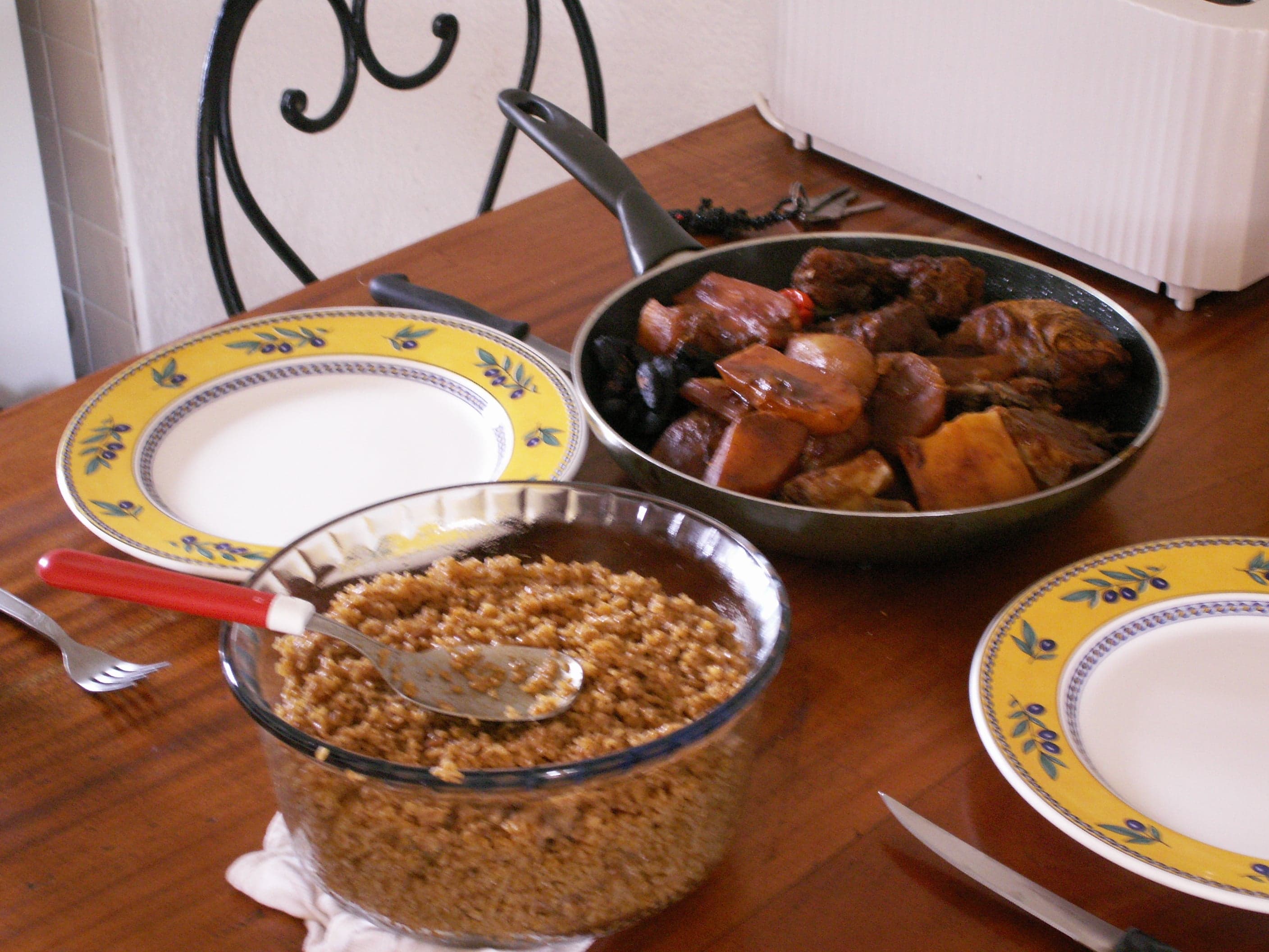 A large plate of thieboudienne with rice, fish, and colourful vegetables