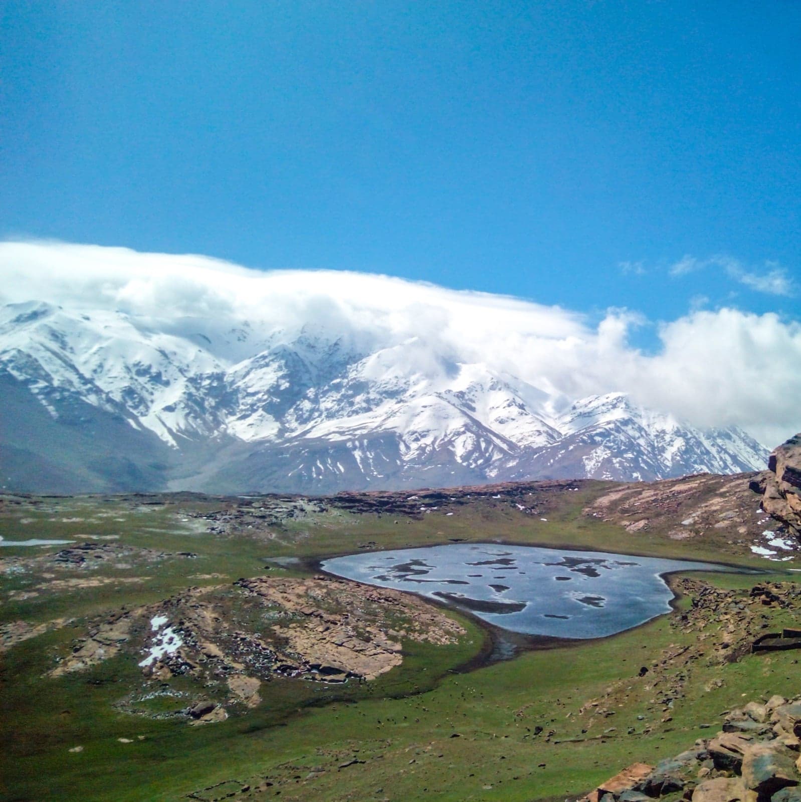 Snow-capped peaks of the High Atlas Mountains rising above a Berber village
