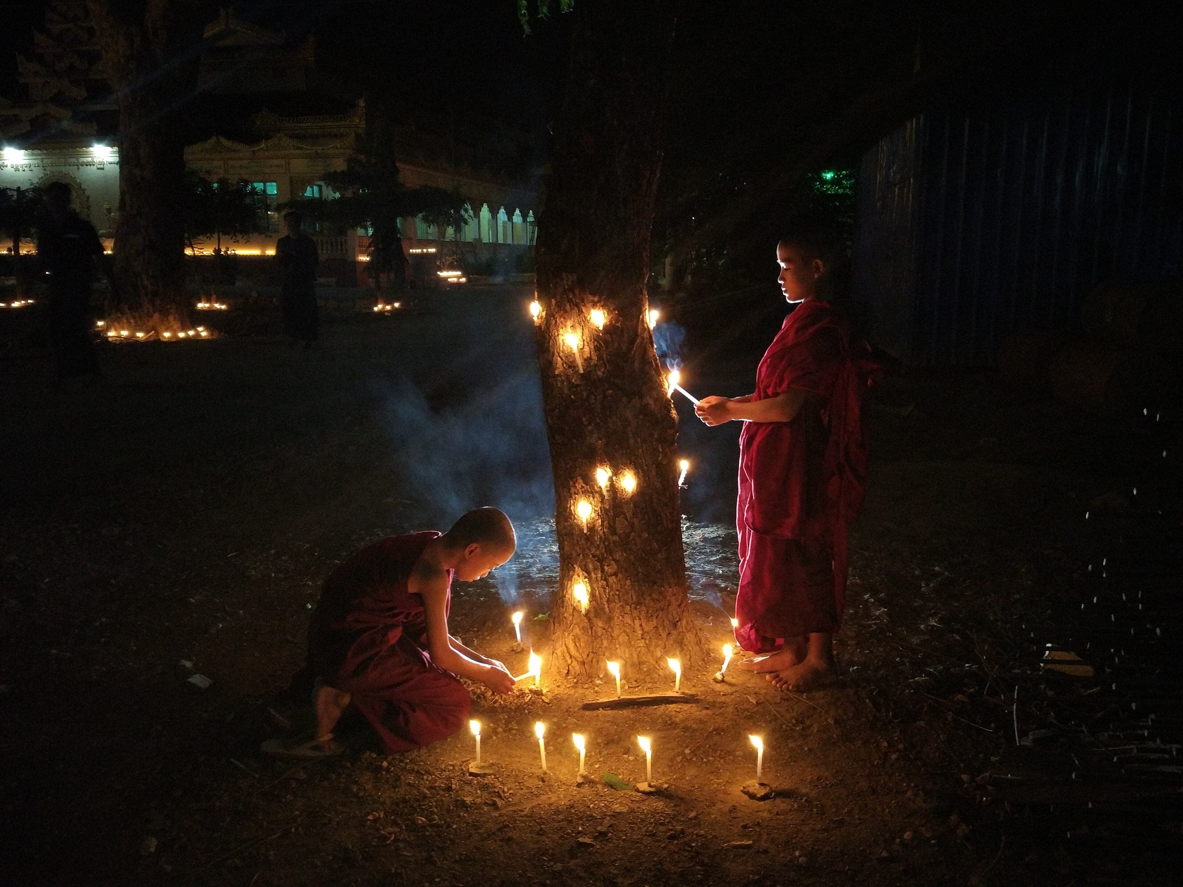 Rows of small oil lamps and candles lighting up steps to a pagoda at Thadingyut