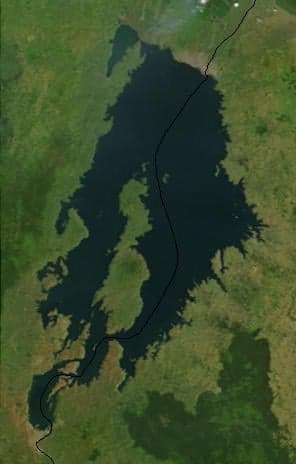 The blue waters of Lake Kivu seen from a green Rwandan hillside