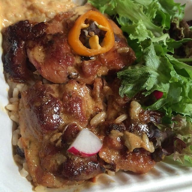 A pot of pelau rice with chicken, pigeon peas and vegetables