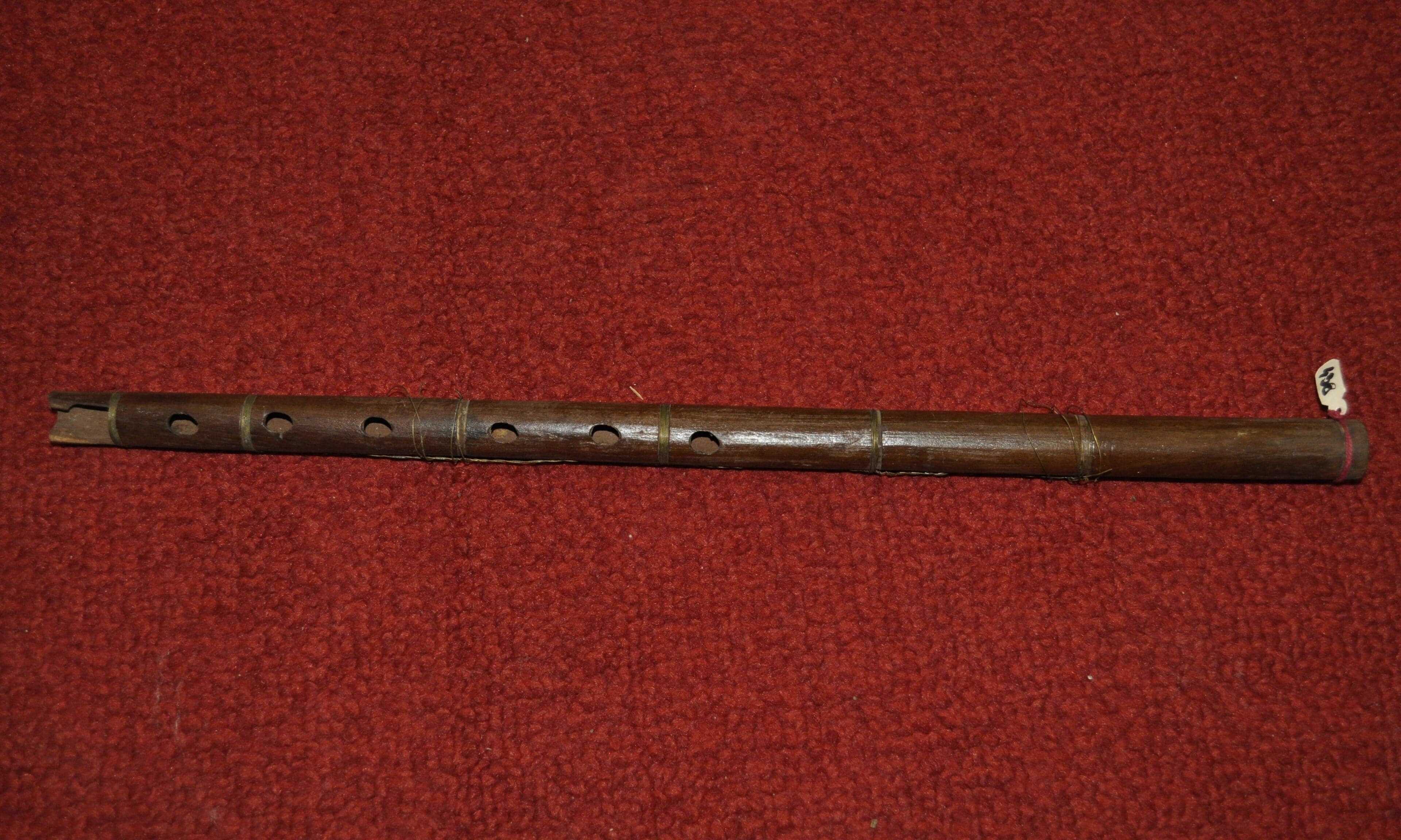 A traditional Serbian frula wooden flute on a wooden table