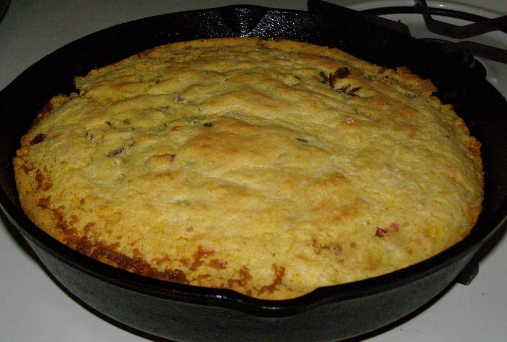 A square of golden proja Serbian cornbread on a wooden board