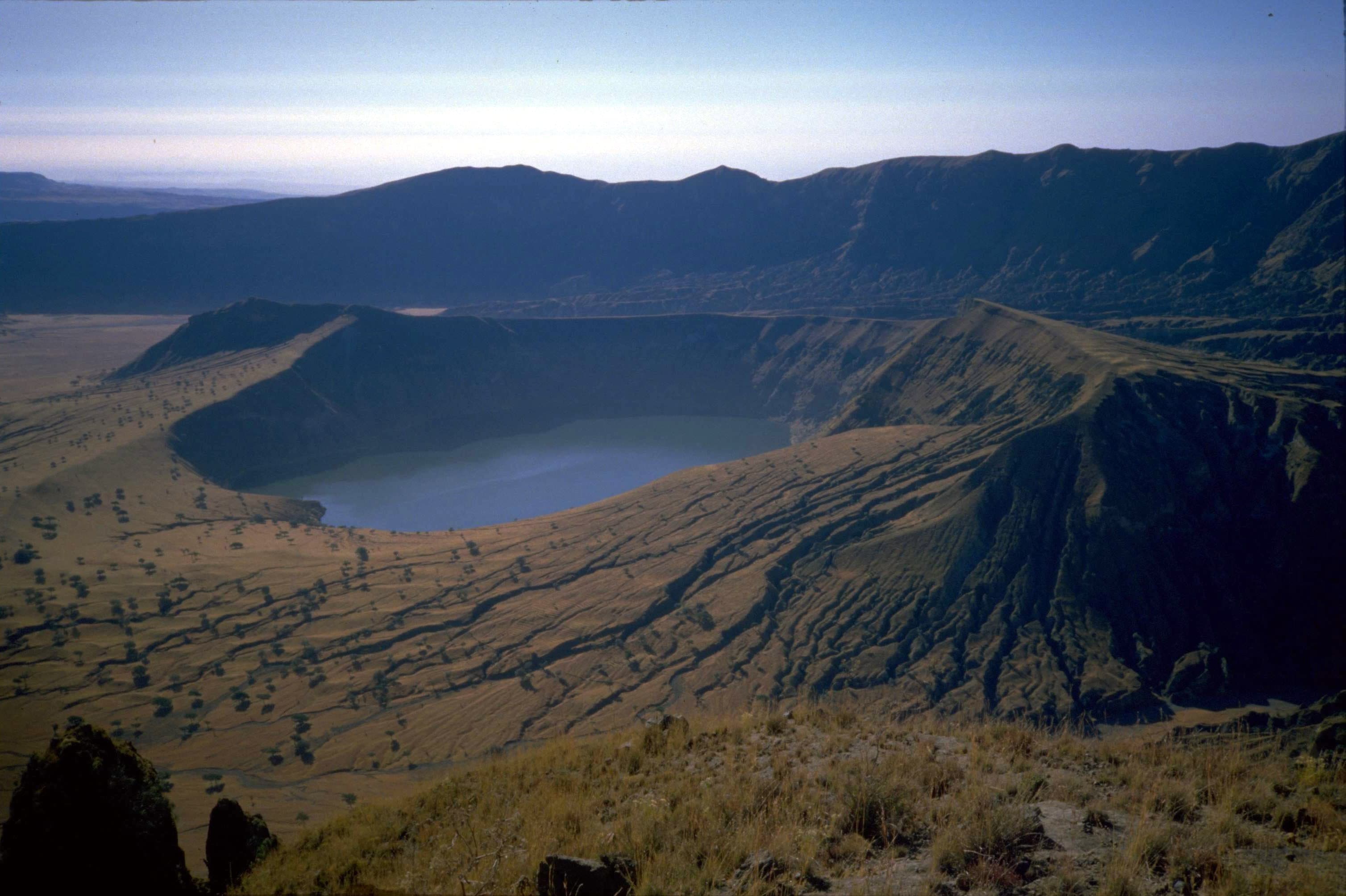 Green volcanic slopes and a crater lake of Jebel Marra rising above the surrounding plains in Sudan