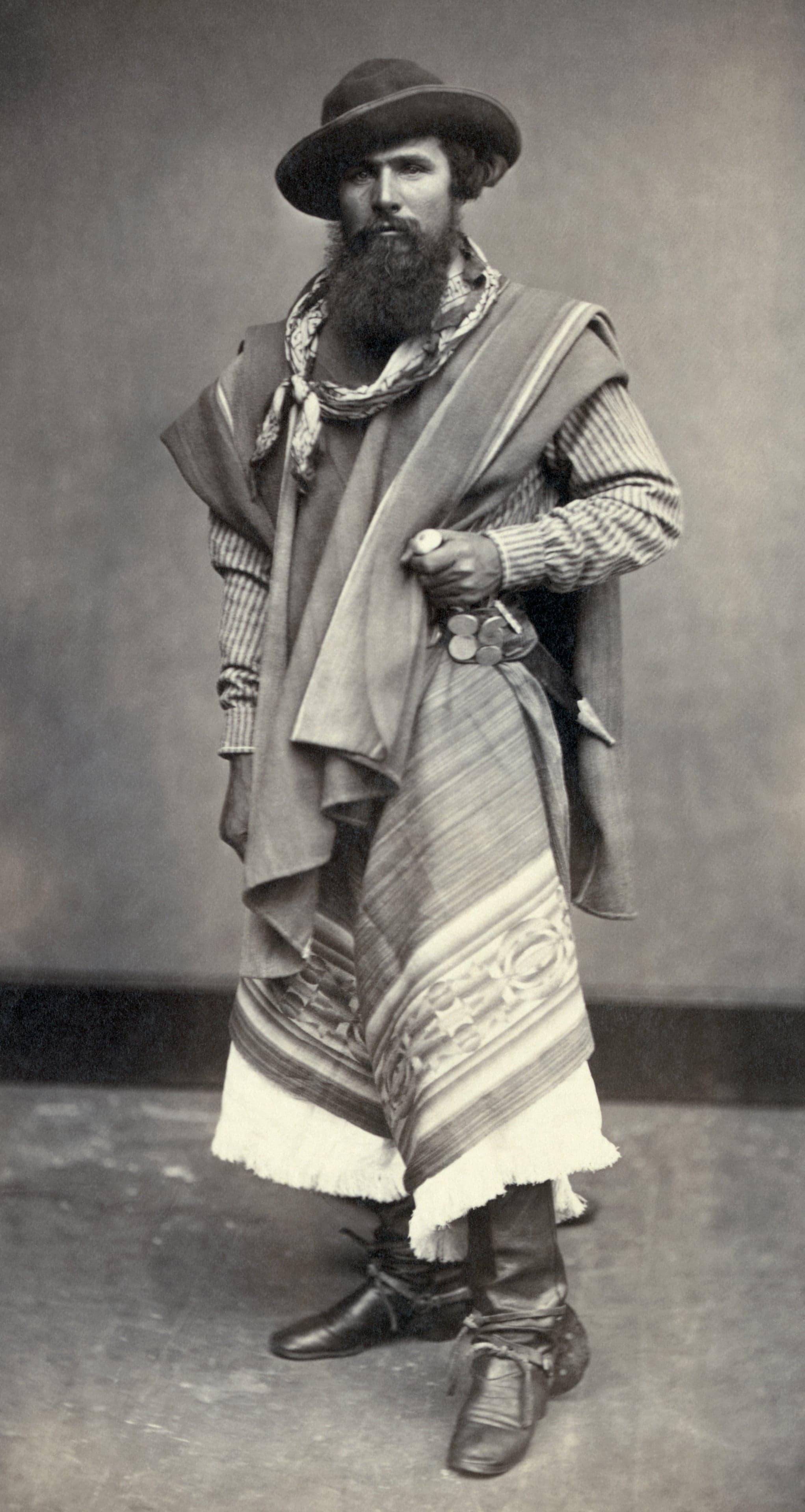 A gaucho on horseback wearing traditional clothing on the open pampas of Uruguay